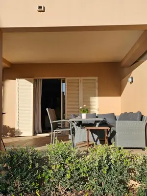 a patio with a table and chairs on a porch at Citadela I, Golfe, Pool and Falesia Beach in Vilamoura