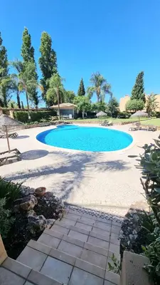 a large swimming pool in the middle of a yard at Citadela I, Golfe, Pool and Falesia Beach in Vilamoura