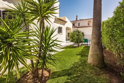 a yard with palm trees and a house at Villa Marquesa in Guia