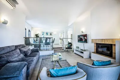 a living room with a couch and a fireplace at Villa Marquesa in Guia
