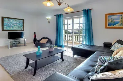 a living room with a couch and a table at Villa Licinia in Guia