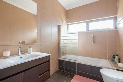 a bathroom with a sink and a tub and a toilet at Jardins Marina Stars in Albufeira