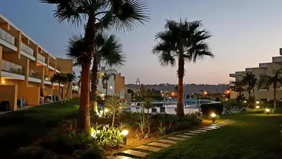 a resort with palm trees and a parking lot at Jardins Marina Stars in Albufeira