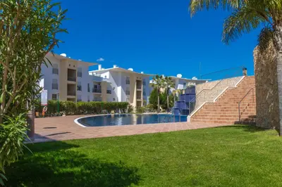 a swimming pool in front of some apartment buildings at #004 Orada by Home Holidays in Albufeira