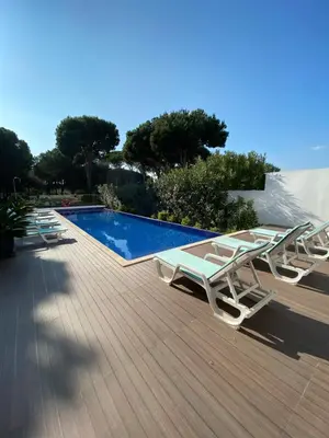 a deck with lounge chairs and a swimming pool at Amora Villa - Vilamoura in Vilamoura
