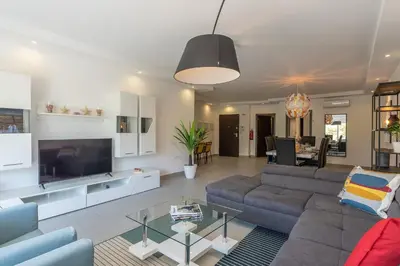 a living room with a couch and a tv at VERASOL 3 in Albufeira