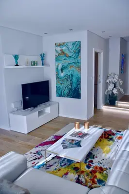 a living room with a couch and a tv at Amora Villa Sacha in Vilamoura