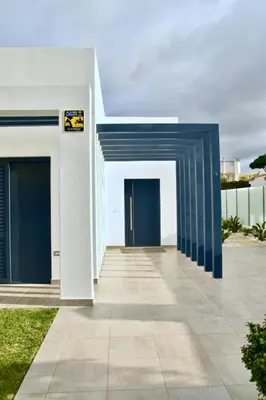 a building with blue doors on the side of it at Amora Villa Sacha in Vilamoura