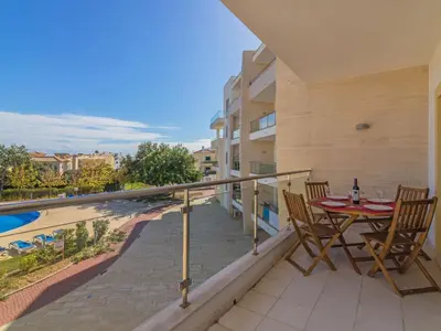 a balcony with a table and chairs overlooking a swimming pool at Apartment Monte da Eira by Interhome in Brejos