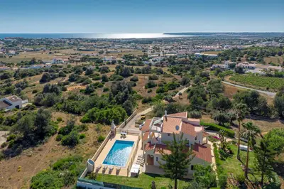 an aerial view of a house with a swimming pool at Villa Mirante in Albufeira