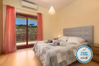 a bedroom with a bed and a window with a view at Villa 14 Marina de Albufeira in Albufeira
