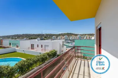 a balcony with a view of a pool and a building at Villa 14 Marina de Albufeira in Albufeira