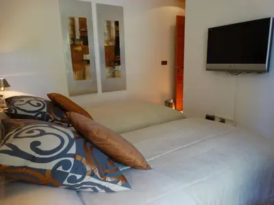a bedroom with a bed and a flat screen tv at Apartamento com 3 quartos e piscina in Vale do Lobo