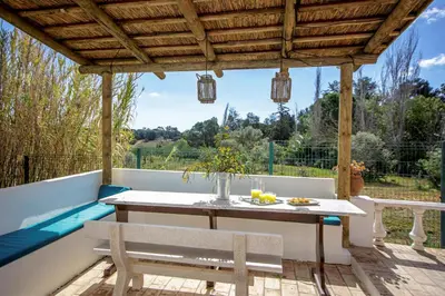 a patio with a table and chairs and a pool at villa yvonne,private pool,private parking 1,7 km from the beach in Albufeira