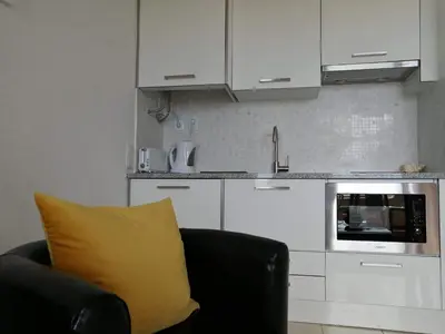 a yellow pillow sitting on a couch in a kitchen at Sea View 3 in Albufeira