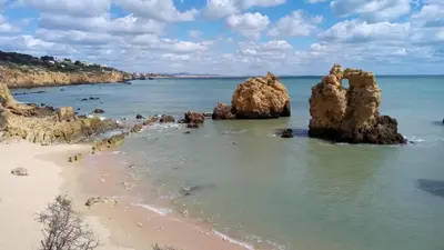 a view of a beach with rocks in the water at Sea View 3 in Albufeira