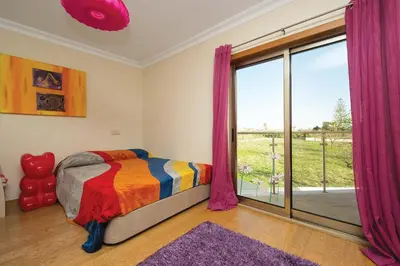 a bedroom with a bed and a large window at Villa Lote 7 by Gabi Miguel in Guia