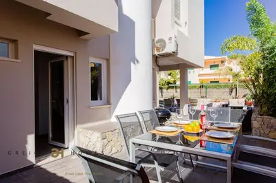 a table and chairs on the patio of a house at Villa Oriente - Greice Homes in Vilamoura