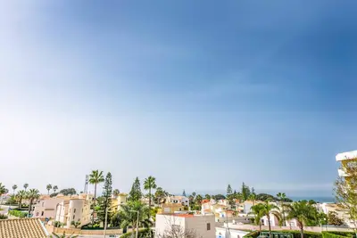 a view of a city with palm trees and buildings at Villa Jomar in Guia