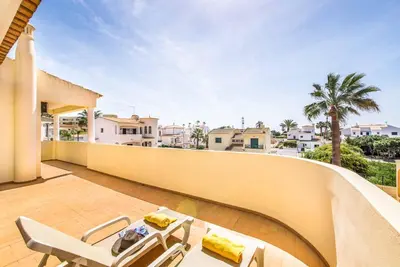 a balcony with two chairs and a table on a building at Villa Simoes in Guia