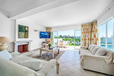 a living room with two couches and a fireplace at Villa Damara in Albufeira