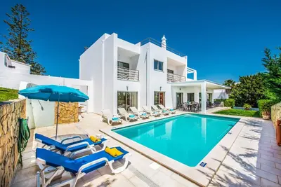 a villa with a swimming pool and a house at Villa Sao Joao in Caliços