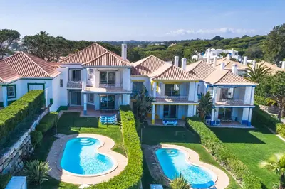 an aerial view of a house with two swimming pools at Encosta Do Lago Resort Club in Quinta do Lago