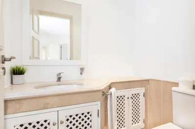 a bathroom with a sink and a mirror at Encosta Do Lago Resort Club in Quinta do Lago