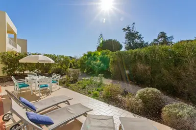 a dog is sitting in a wood fired oven on a patio at Villas Sol e Poesia in Albufeira