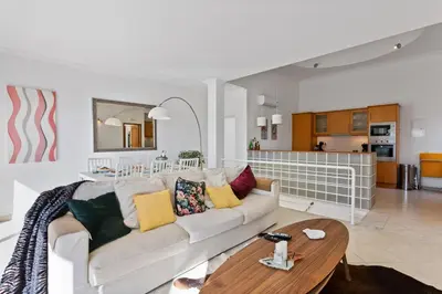 a kitchen with two bar stools and a counter at Villas Sol e Poesia in Albufeira