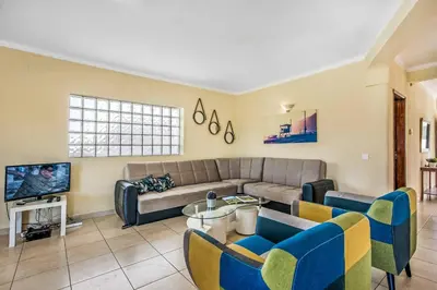 a living room with a couch and a tv at Villa Charlota in Albufeira
