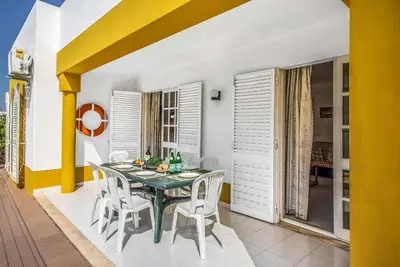 a dining room with a table and chairs at Villa Arines in Albufeira