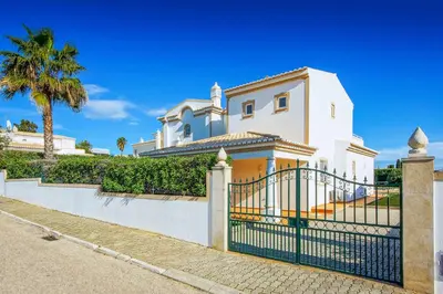 a bedroom with a large bed and a window at Villa Beatrice in Albufeira