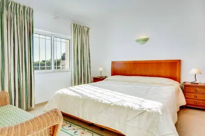 a white bathroom with a tub and a sink at Villa Beatrice in Albufeira