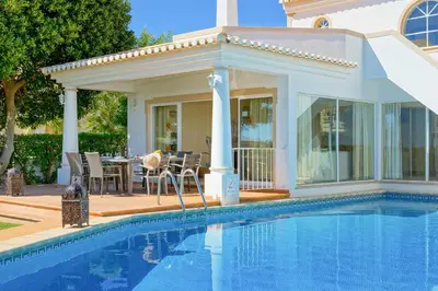 a house with a swimming pool in front of a house at Villa Adele in Albufeira