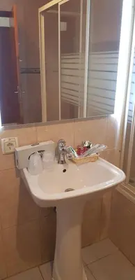 a white sink in a bathroom with a mirror at Villa Brigida in Albufeira