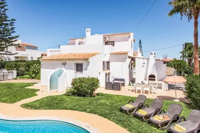 a villa with a swimming pool and a house at Villa Severino in Albufeira