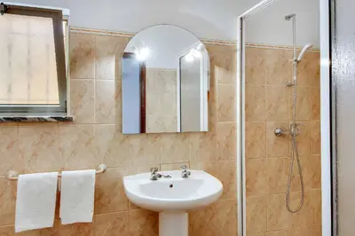 a bathroom with a sink and a shower at Villa Coelha in Albufeira