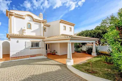 a white house with a porch and a driveway at Villa Ceylon in Albufeira