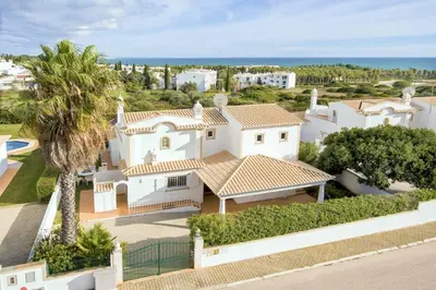 an aerial view of a white house with a palm tree at Villa Ceylon in Albufeira