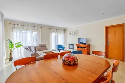 a living room with a wooden table and chairs at Casa Ferrero in Guia