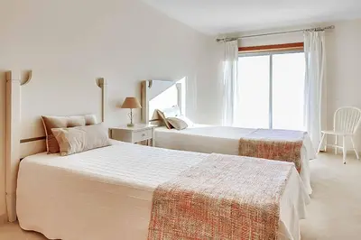 a bedroom with two beds and a window at Casa Ferrero in Guia