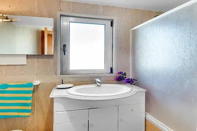 a bathroom with a sink and a window at Casa Ferrero in Guia