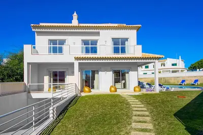 a white house with a yard and a fence at Casa Ferrero in Guia