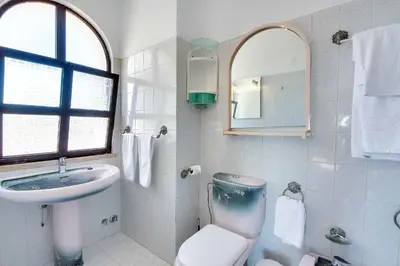 a bathroom with a toilet and a sink and a mirror at Villa Albuar in Albufeira