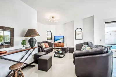 a living room with two couches and a table at Casa dos Amigos in Albufeira