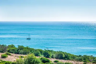 a boat in the water on the ocean at Villa Oceano in Albufeira