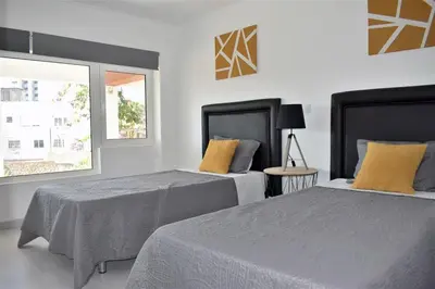 a bedroom with two beds and a window at Rua José Afonso in Albufeira