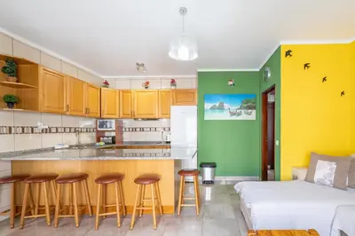 a kitchen with a counter and stools in a room at Apartamentos Old Town by Umbral in Albufeira