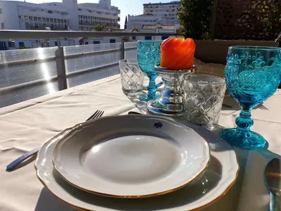 a table with a plate and glasses on a table at SunHouse Room in Albufeira